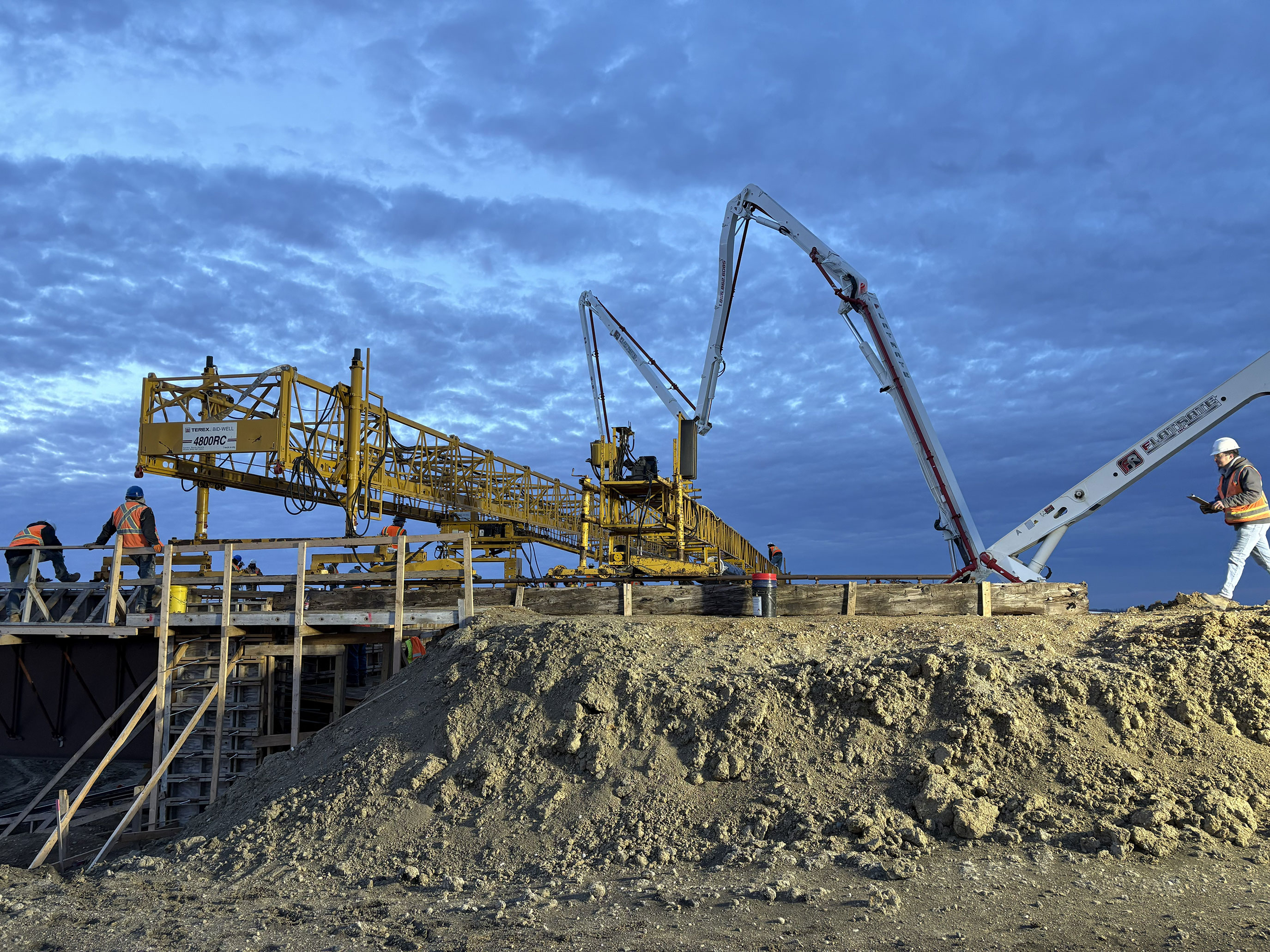 Crane on construction site at night.
